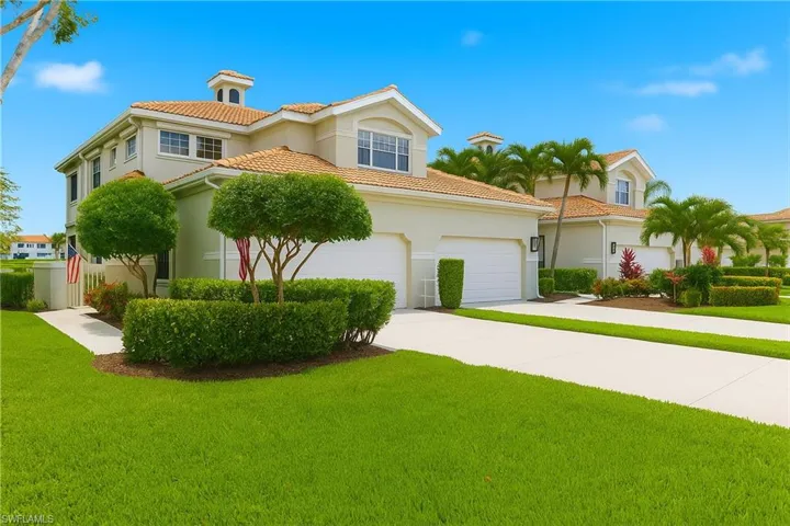 Mediterranean / spanish house featuring stucco siding, concrete driveway, a front lawn, and a tiled roof
