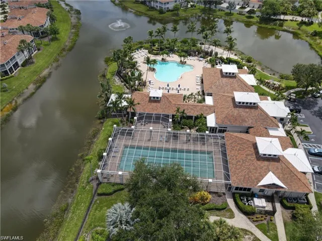 Aerial view of property's location with a pool area and a nearby body of water