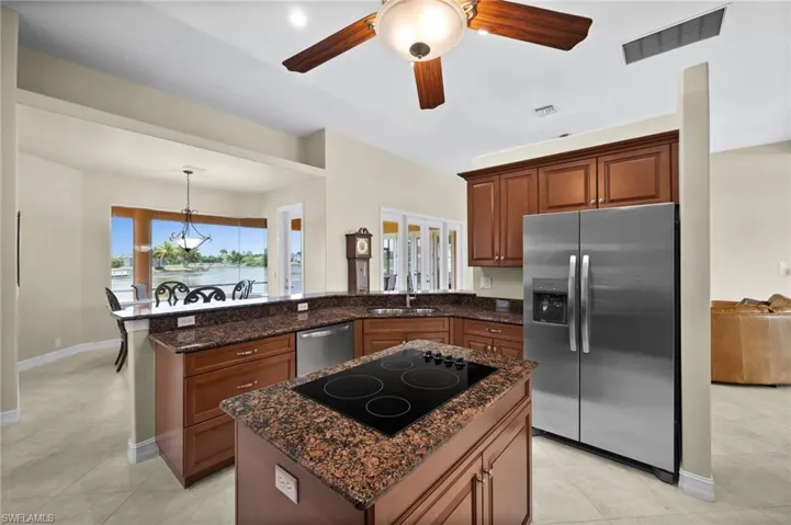 Island with cooktop and a view of the water