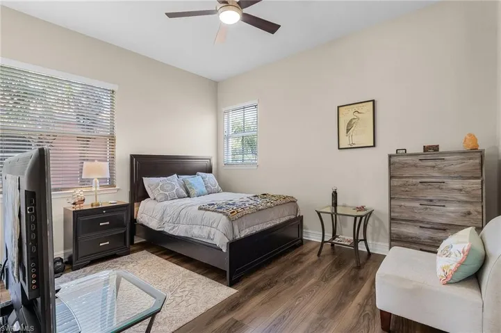 Bedroom featuring dark hardwood / wood-style floors and ceiling fan
