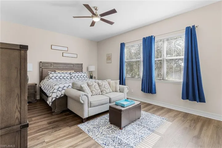 Bedroom with ceiling fan and hardwood / wood-style flooring