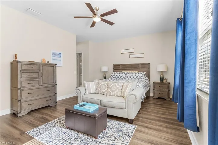 Bedroom with ceiling fan and wood-type flooring