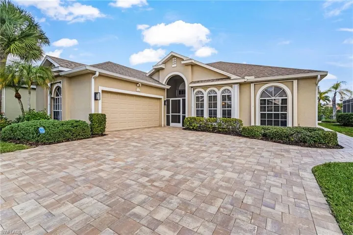 Single story home featuring stucco siding, a garage, decorative driveway, and a shingled roof