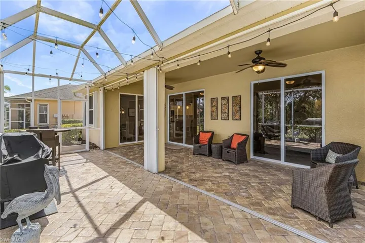 View of patio featuring ceiling fan, a sunroom, a grill, and a lanai