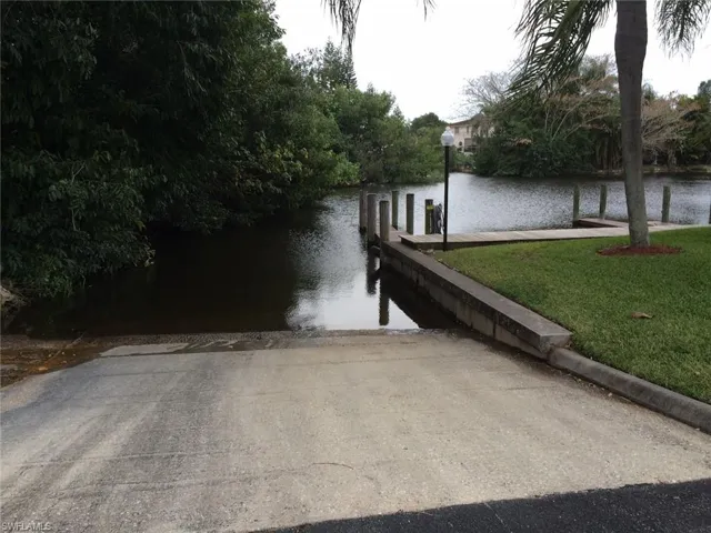 Dock area with a boat ramp and a water view