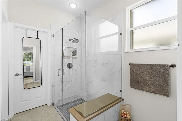 Bathroom with a marble finish shower