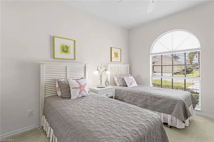 Bedroom with light carpet and ceiling fan
