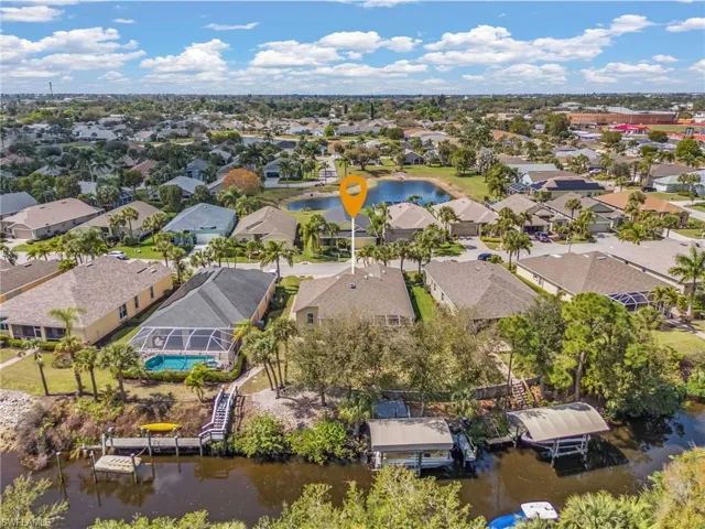Aerial perspective of suburban area with a nearby body of water