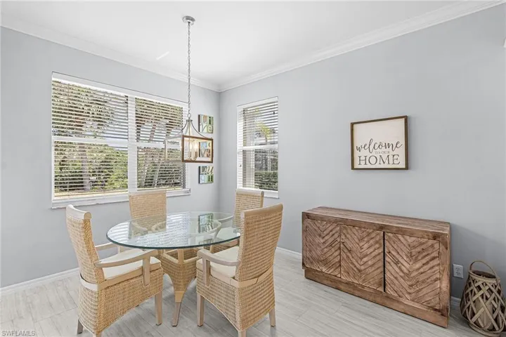 Dining space featuring crown molding and baseboards