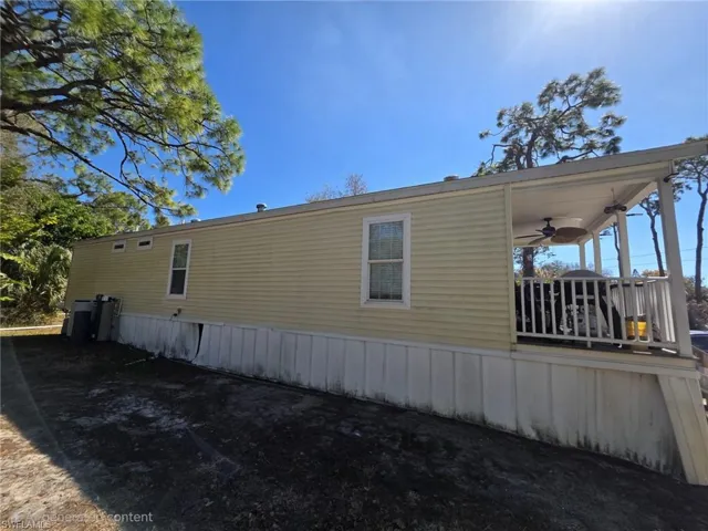 View of side of property with a ceiling fan