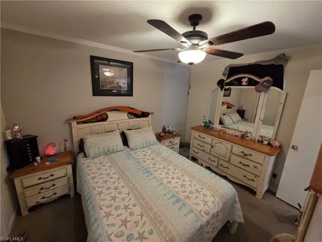 Bedroom with ornamental molding and ceiling fan