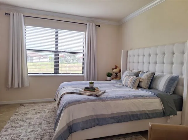 Neutral wall palette featuring crown molding and a large window with blind treatments
