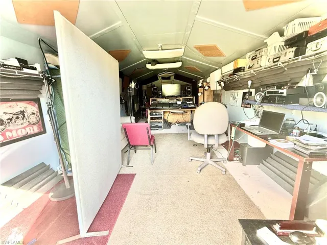 Office area featuring vaulted ceiling