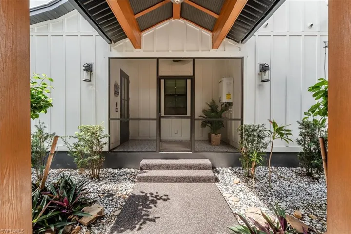 View of property side entrance from the carport