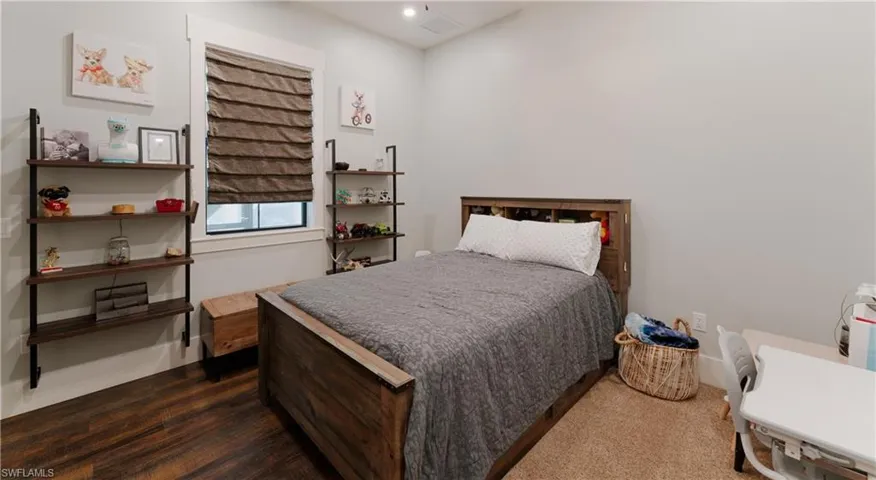 Bedroom with dark hardwood / wood-style floors