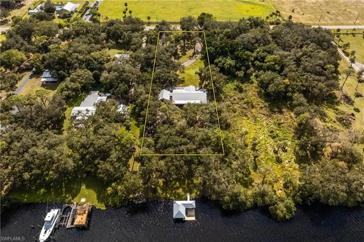 Birds eye view of property with a water view