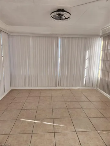 Spare room with plenty of natural light and light tile patterned floors