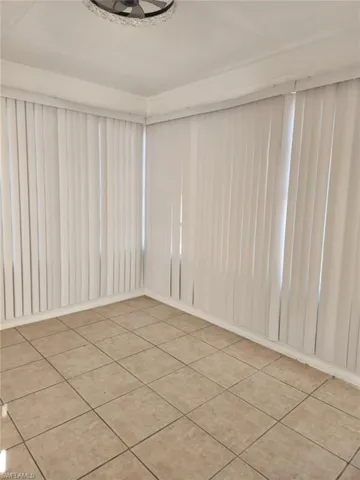 Unfurnished room featuring light tile patterned floors