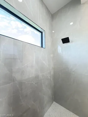 Bathroom with a marble finish shower