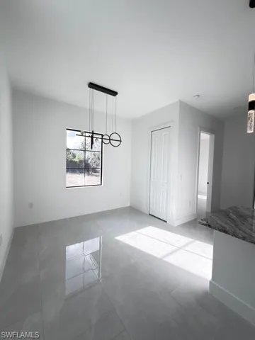 Unfurnished dining area with baseboards