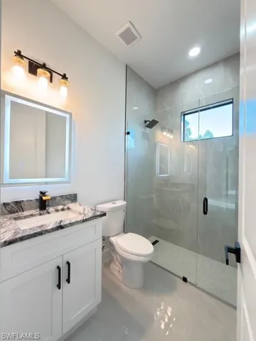 Bathroom with vanity and a stall shower