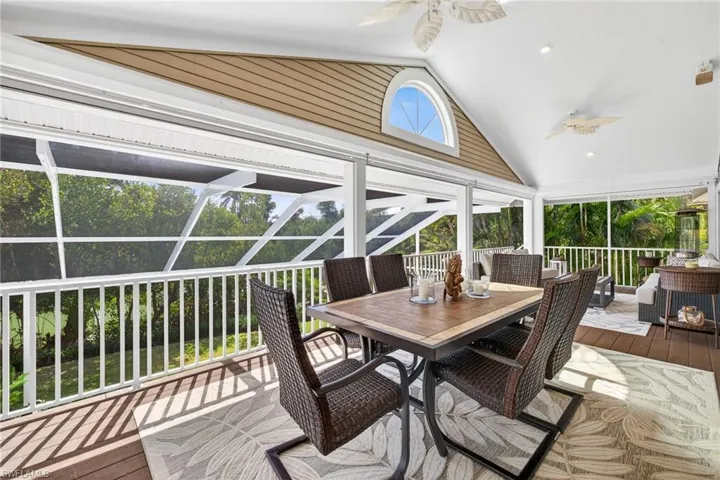 Sunroom featuring ceiling fan and outdoor dining area