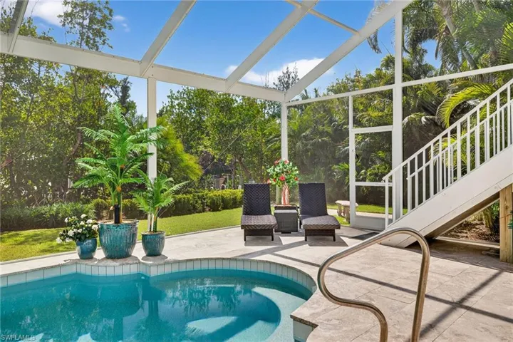 Swimming pool with a sunroom and a patio area