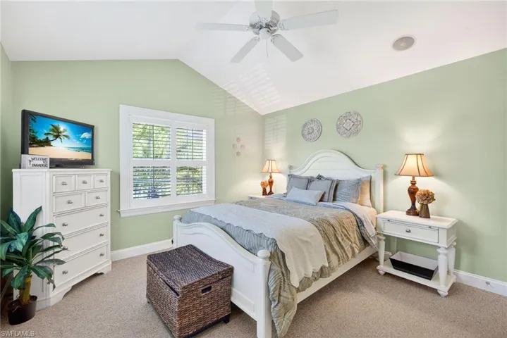 Carpeted bedroom featuring baseboards and a ceiling fan