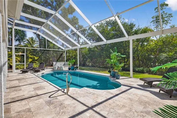 Outdoor pool featuring a lanai, a sunroom, and a patio area