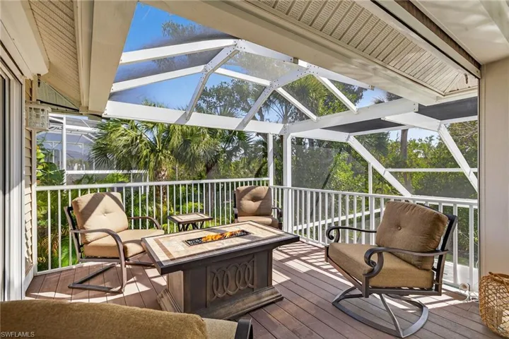 Sunroom featuring a fire pit and a deck