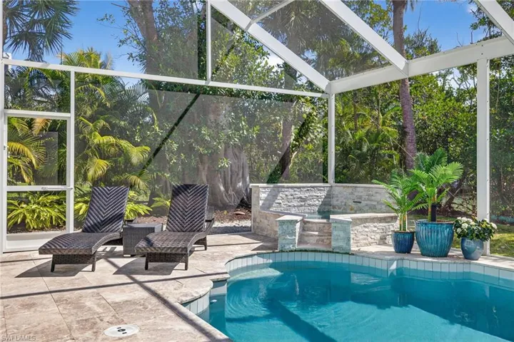 Swimming pool featuring a lanai and a patio area