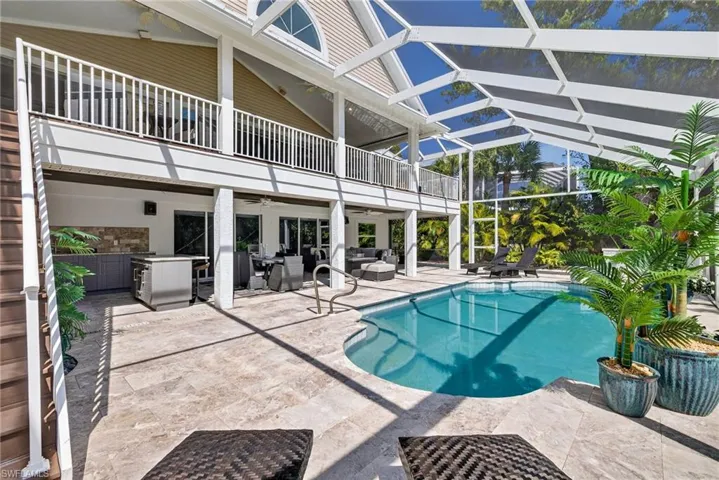 Swimming pool with a patio area, an outdoor hangout area, a sunroom, and a lanai