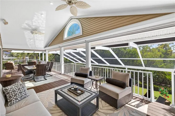 Sunroom / solarium featuring an outdoor living / dining area, ceiling fan, and a wooden deck