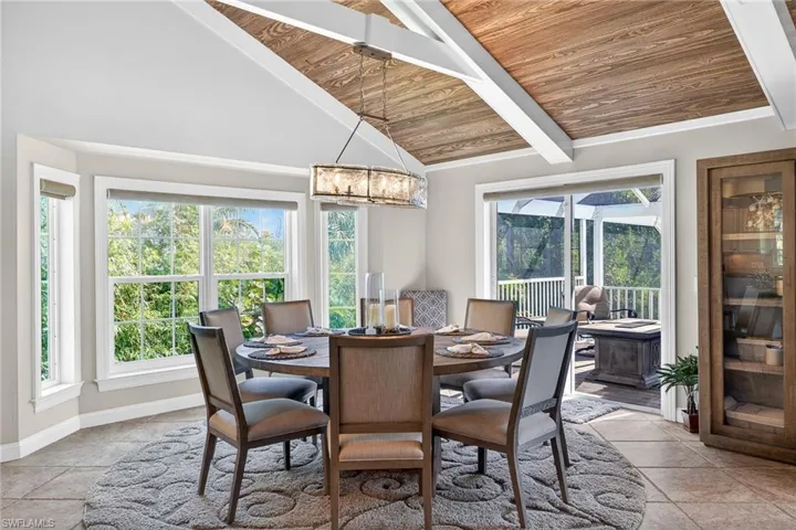 Dining space featuring a high wood beamed ceiling and a chandelier