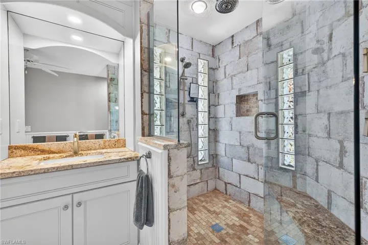 Full bathroom featuring vanity and tiled shower