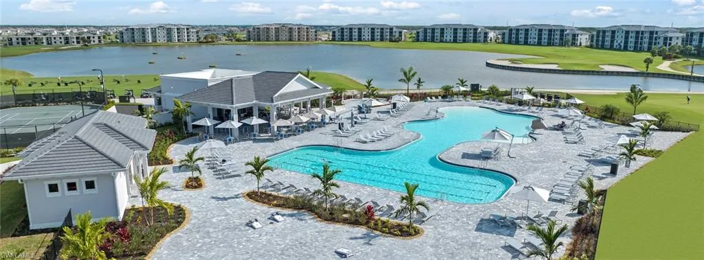 View of swimming pool with a water view and a patio