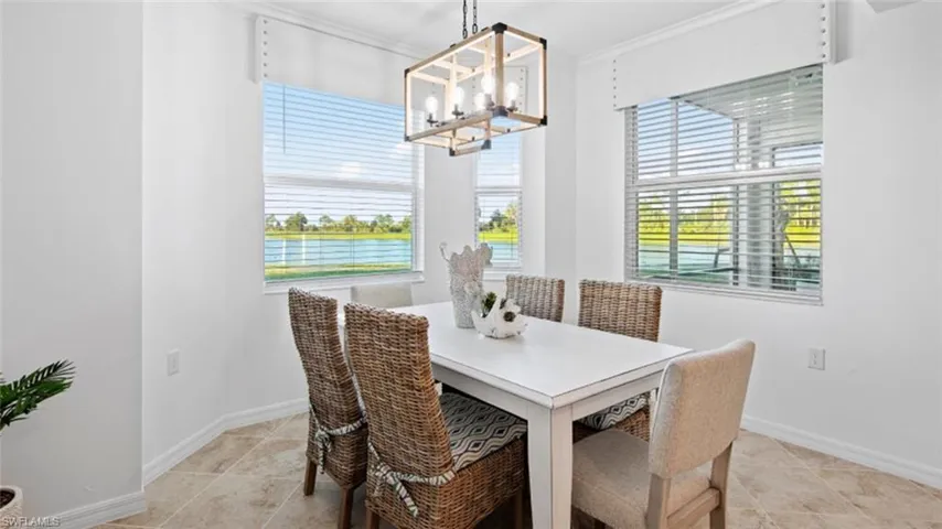 Dining space with crown molding, a chandelier, and a healthy amount of sunlight