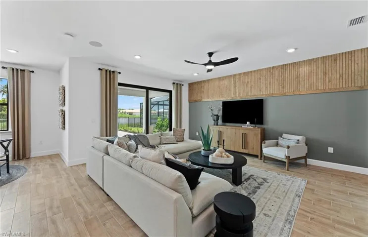Living area with light wood finished floors, a ceiling fan, and recessed lighting