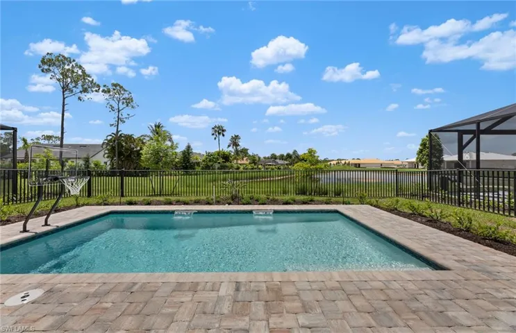 View of pool with patio surround, a fenced backyard, and a lanai