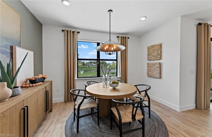 Dining room featuring light wood-style floors and hanging lights