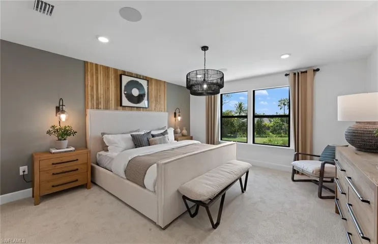 Bedroom featuring light carpet, recessed lighting, and an accent wall