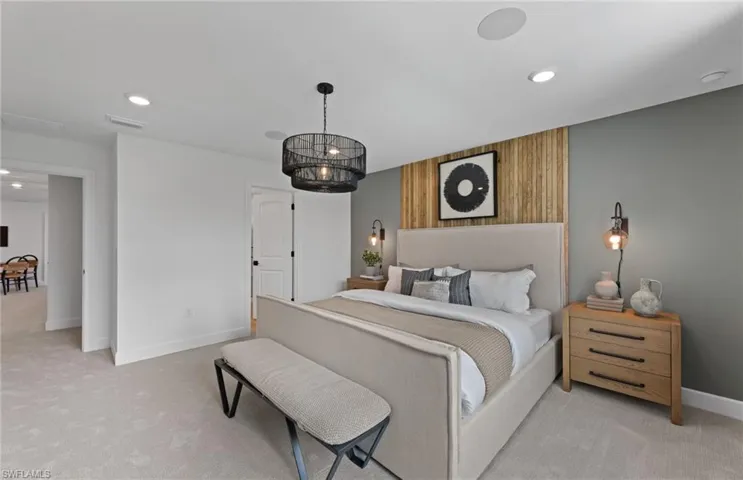 Bedroom with light carpet, recessed lighting, and wood walls