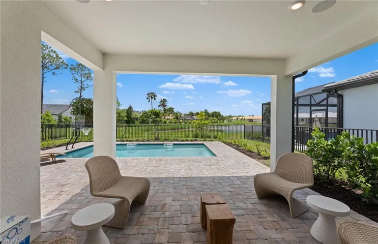View of swimming pool with patio surround and a fenced backyard