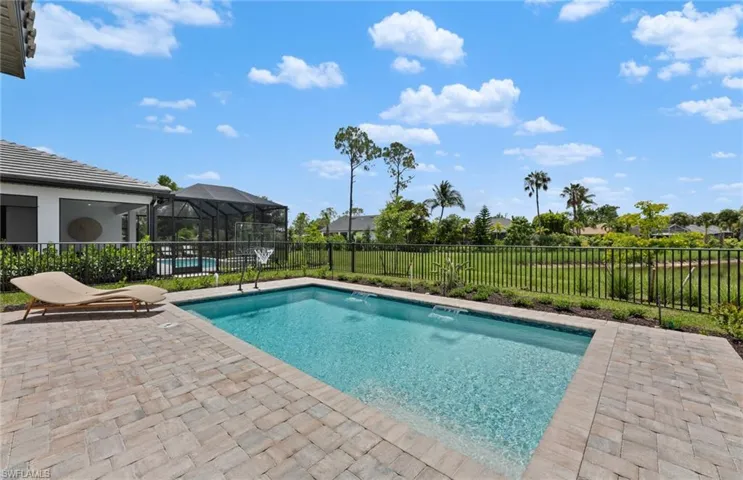 View of swimming pool with patio surround, a lanai, a fenced backyard, and a sunroom