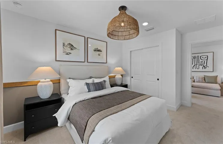 Bedroom with light colored carpet, recessed lighting, and a closet