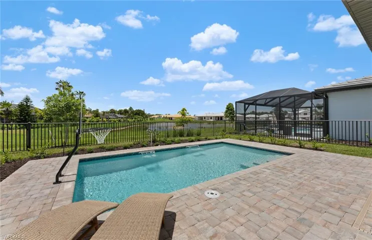 View of pool with patio surround, a lanai, a fenced backyard, and a sunroom