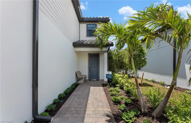 Doorway to property featuring stucco siding