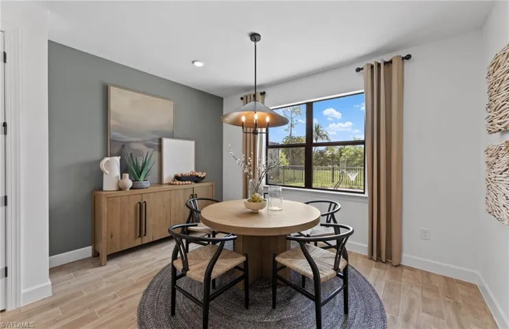 Dining space with wood tiled floors and baseboards