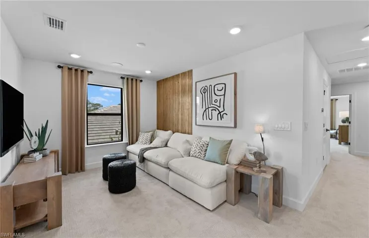Living area featuring light carpet and recessed lighting
