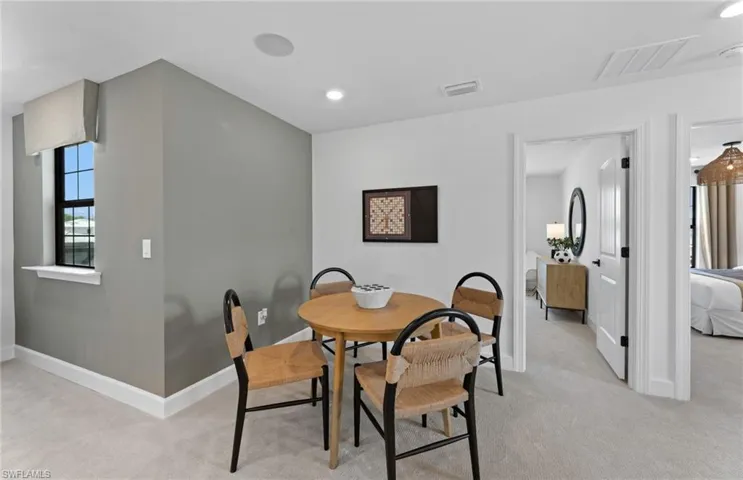 Dining area featuring recessed lighting and light colored carpet